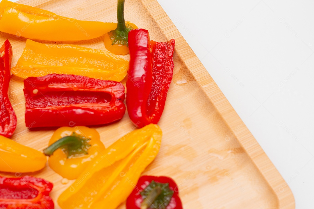 Pimentões vermelhos e amarelos sobre uma tábua