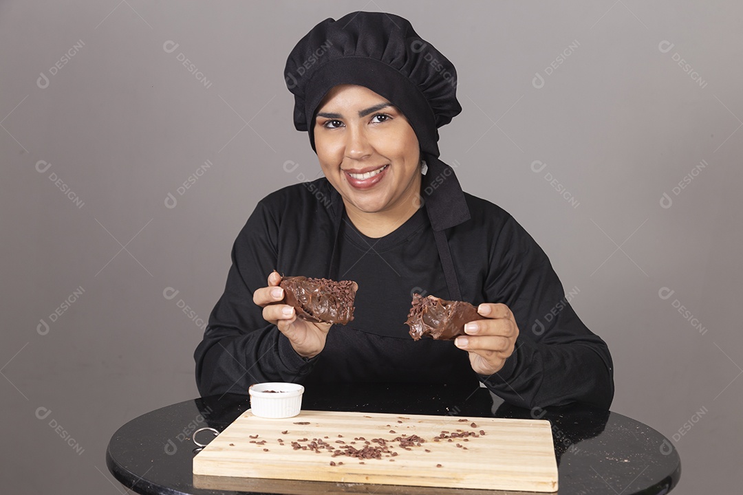 Mulher linda jovem chefe de cozinha comendo ovos de páscoa