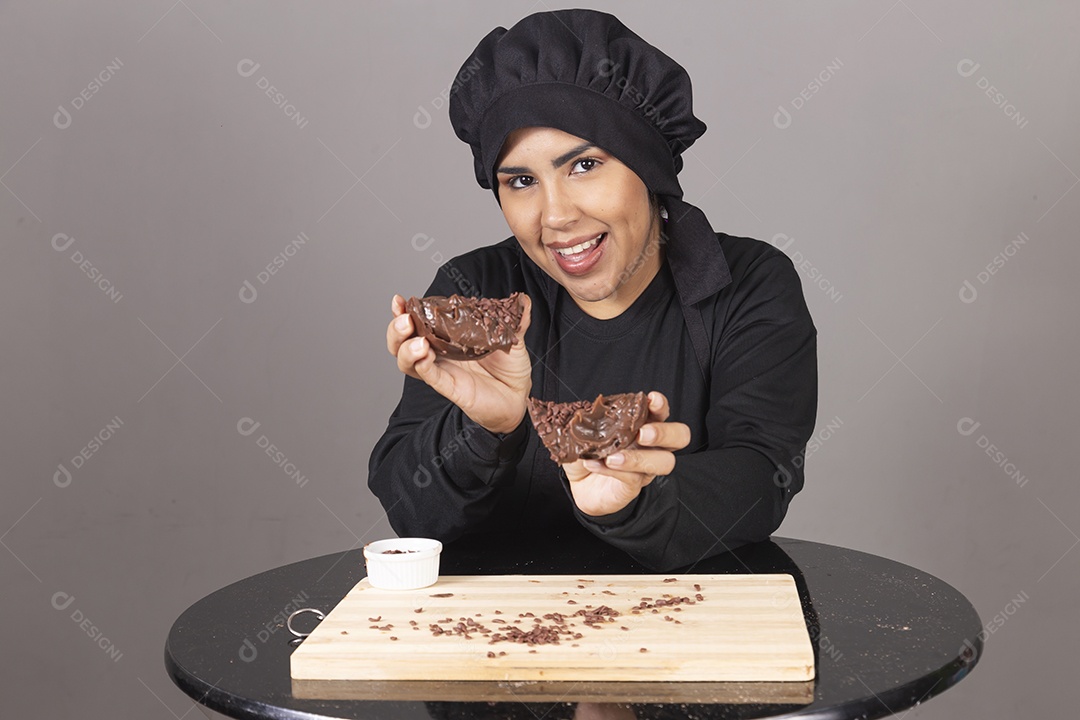 Mulher linda jovem chefe de cozinha comendo ovos de páscoa