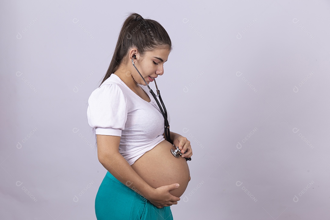 Homem jovem médico ao lado de mulher gravída sobre fundo isolado