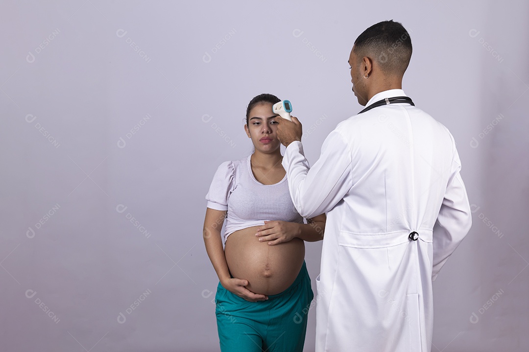 Homem jovem médico ao lado de mulher gravída sobre fundo isolado