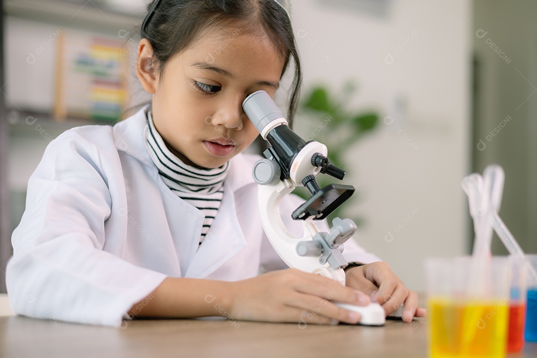 Menina asiática aprendendo química científica com microscópio