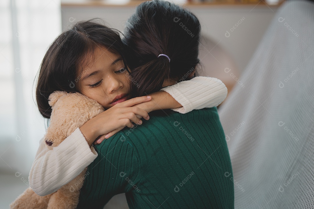 Sad little girl hugging her mother