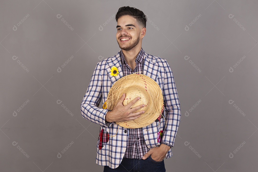 Homem jovem usando roupas típicas de festa junina sobre fundo isolado