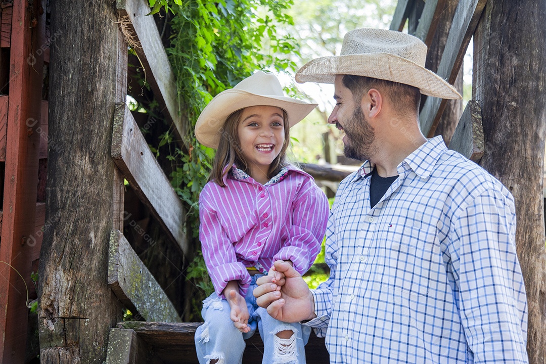 Pai fazendeiro ao lado de sua filha sobre fazenda