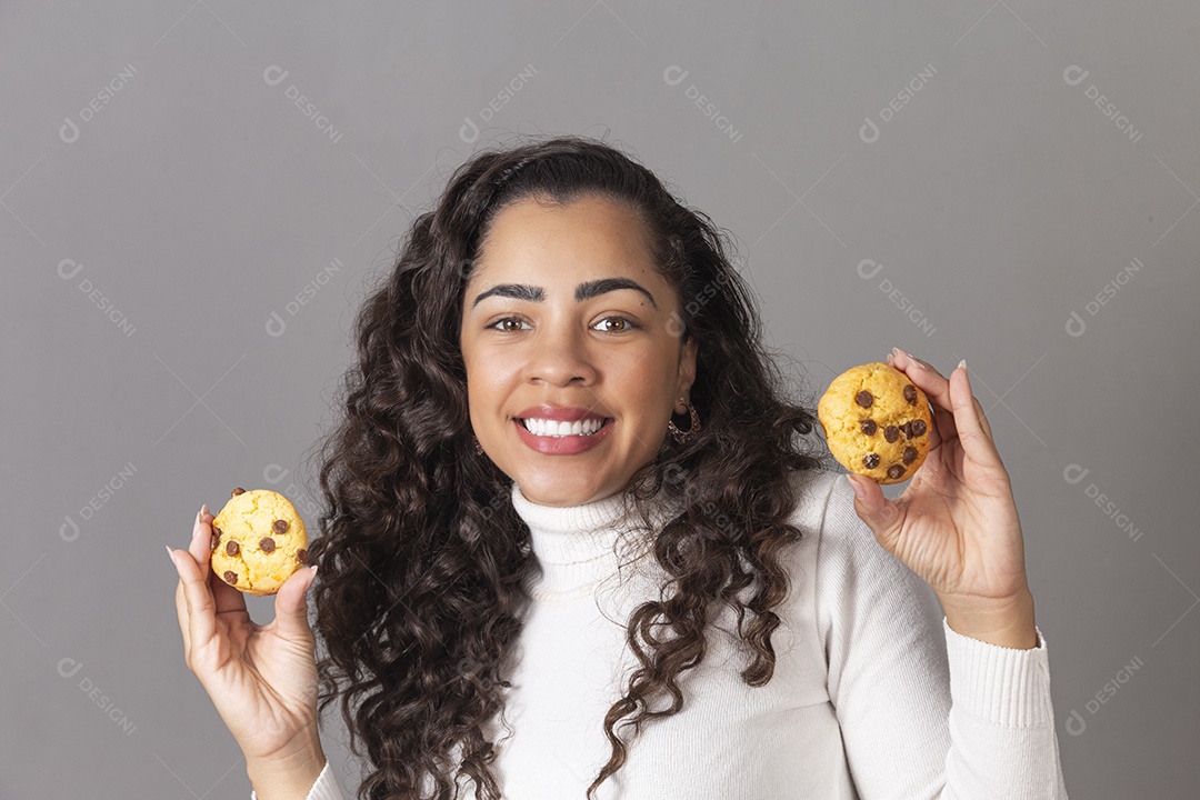 LInda mulher sorridente seguanrando cookie sobre fundo isolado