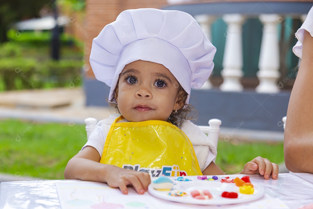 Linda criança fofa usando roupa de chefe de cozinha