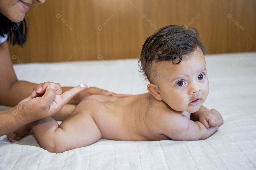 Mãe jovem cuidadando de seu filho sobre quarto