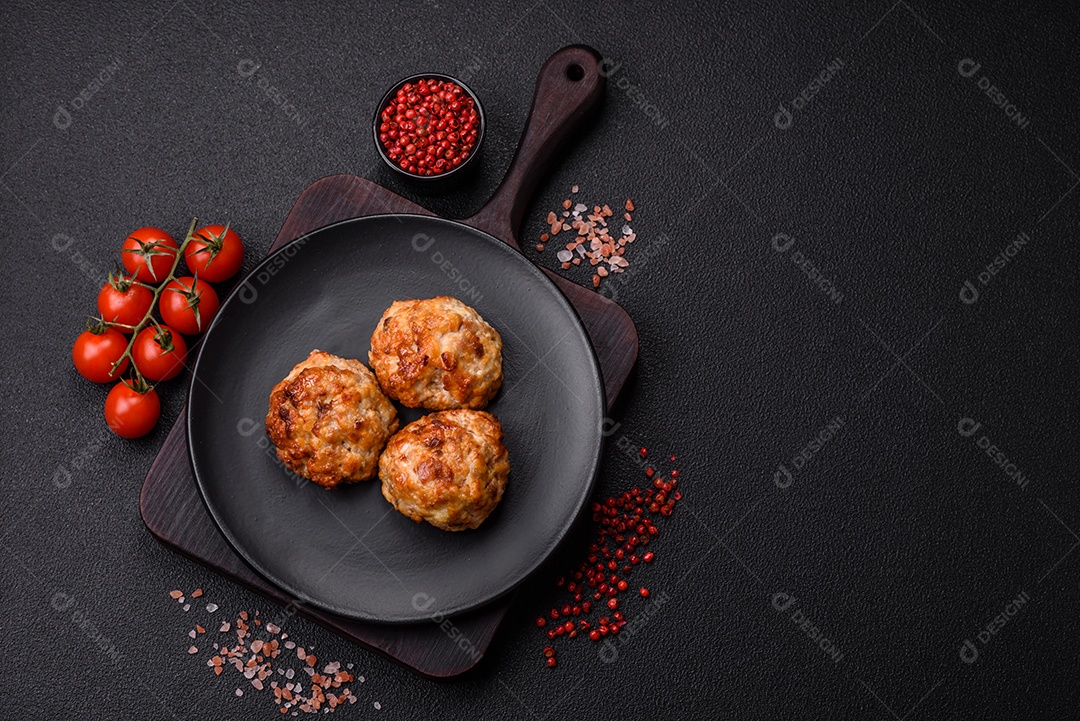 Deliciosas costeletas de peixe picado frito fresco com especiarias e ervas sobre um fundo escuro de concreto