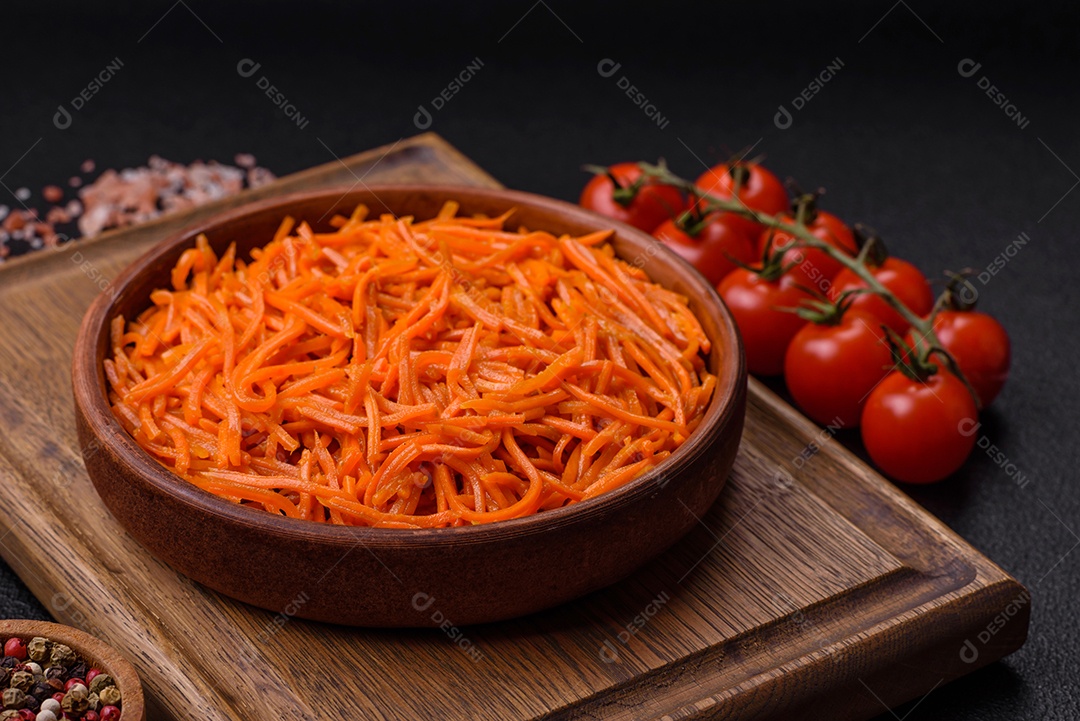 Saborosa cenoura coreana picante com especiarias e ervas em um fundo escuro de concreto. comida asiática