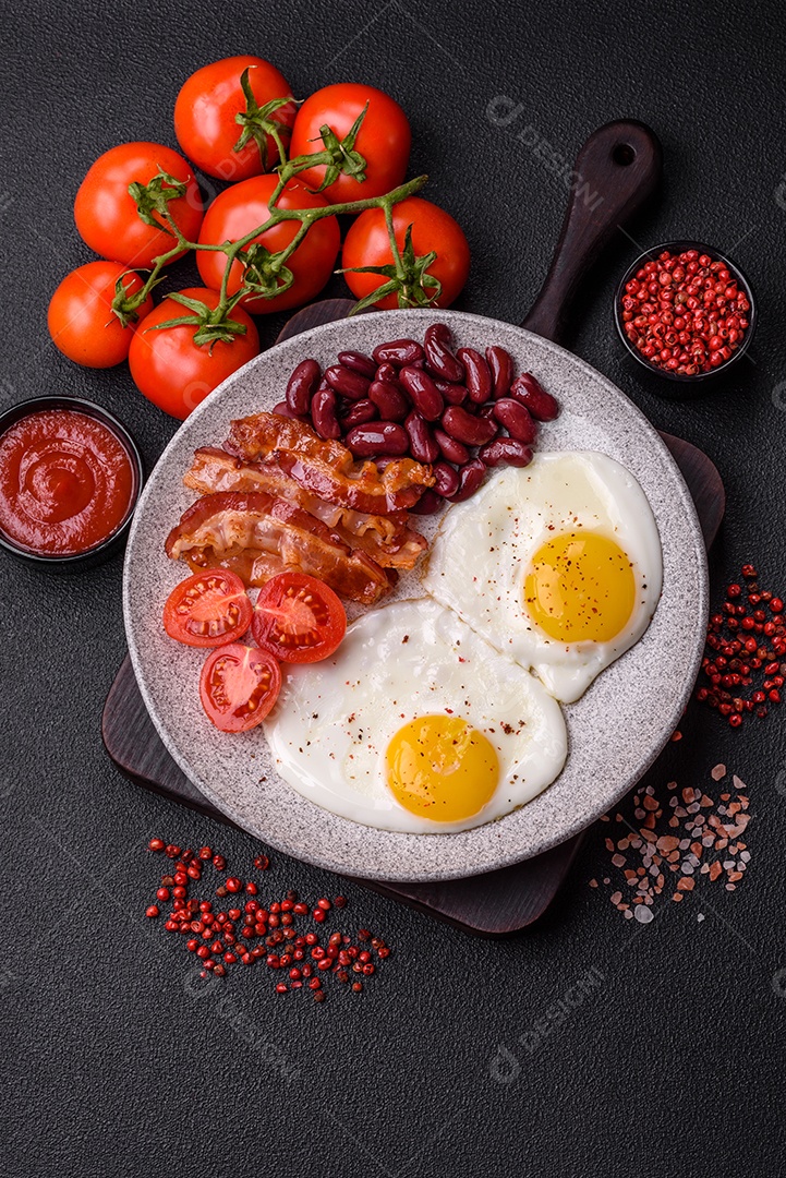 Café da manhã inglês com ovos fritos, bacon, feijão, tomate, especiarias e ervas. Um início de dia saudável e nutritivo