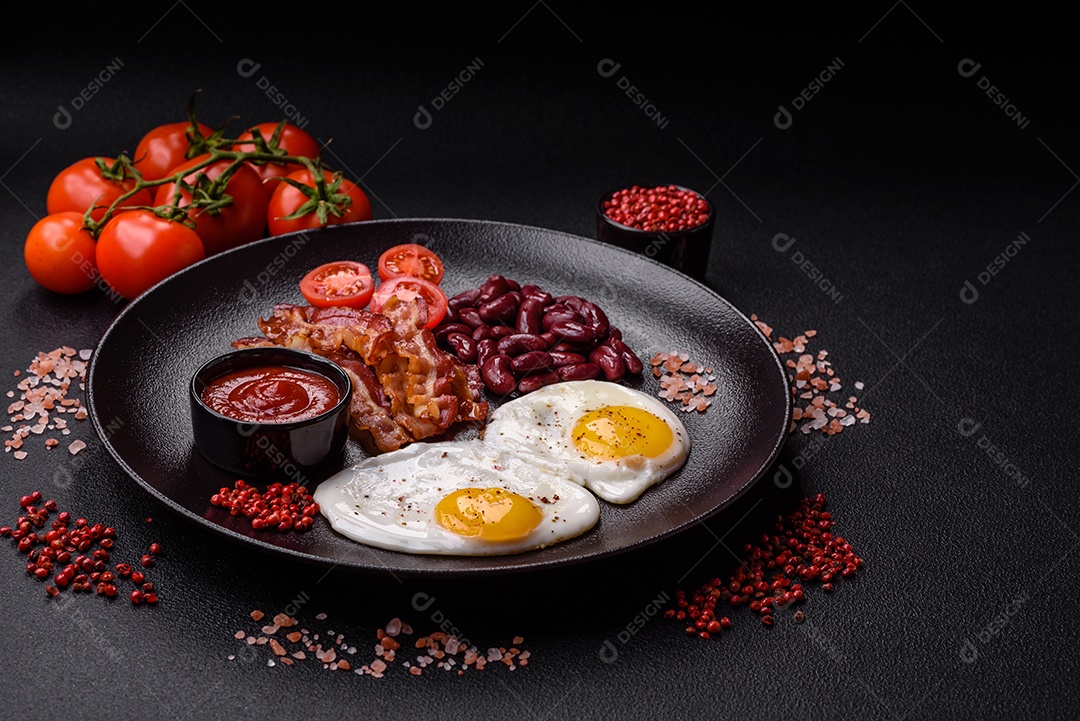 Café da manhã inglês com ovos fritos, bacon, feijão, tomate, especiarias e ervas. Um início de dia saudável e nutritivo