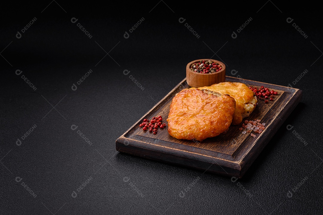 Deliciosa carne frita com mostarda Dijon com sal, especiarias e ervas sobre fundo escuro de concreto