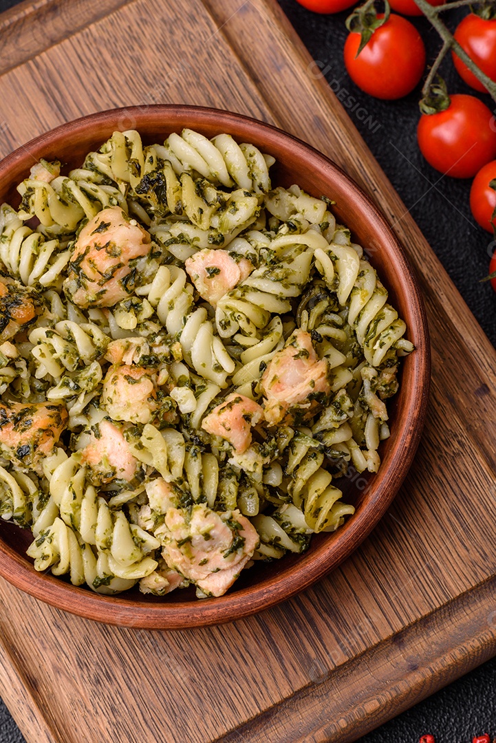 Deliciosa massa com espinafre, salmão, sal e especiarias sobre um fundo escuro de concreto