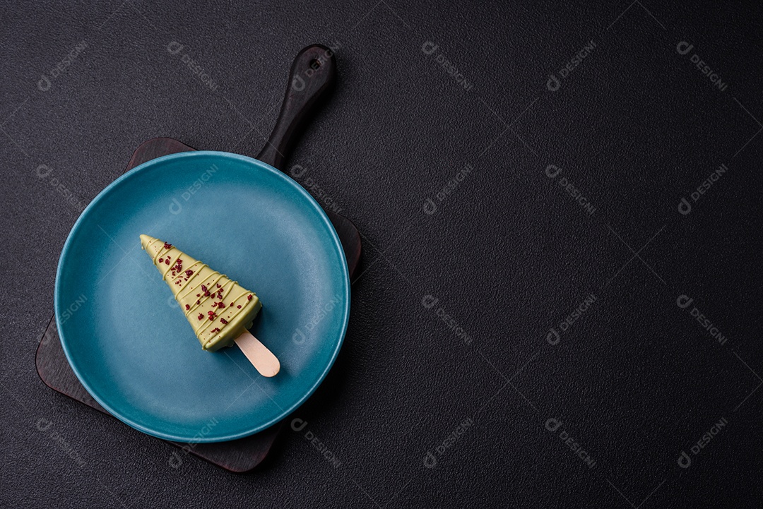 Delicioso cheesecake doce com frutas cobertas de glacê com uma vara de madeira sobre um fundo escuro de concreto