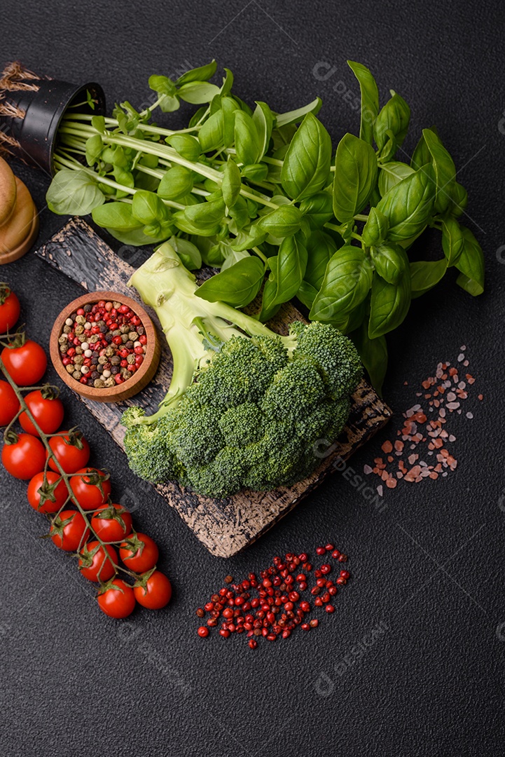 Manjericão de ervas frescas em forma de arbusto como ingrediente para cozinhar em casa sobre um fundo escuro de concreto