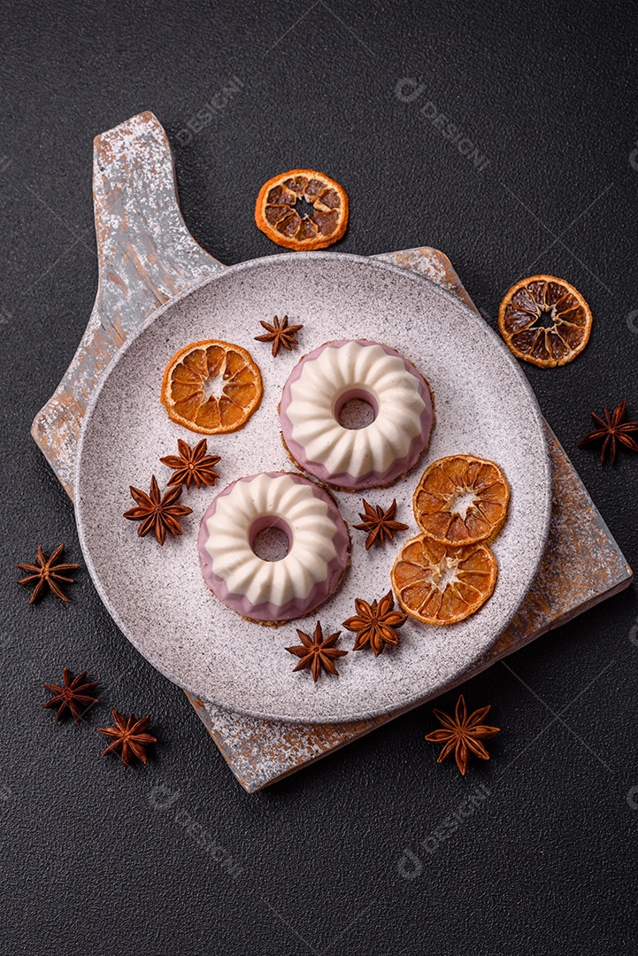 Delicioso cheesecake redondo rosa e branco, sem lactose, sem açúcar, nutrição saudável, sobre um fundo escuro de concreto