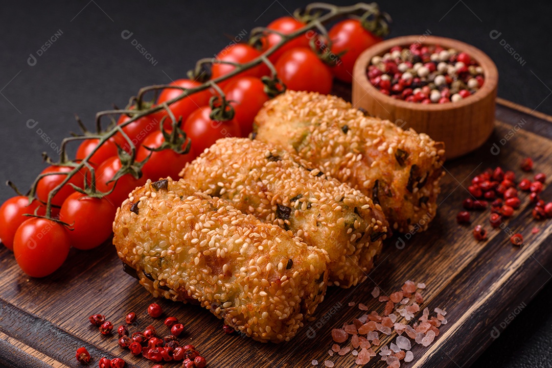 Delicioso prato vegetariano ou vegano em forma de costeletas ou hambúrgueres consistindo de batatas, cenouras, cebolas e feijões em um fundo escuro de concreto