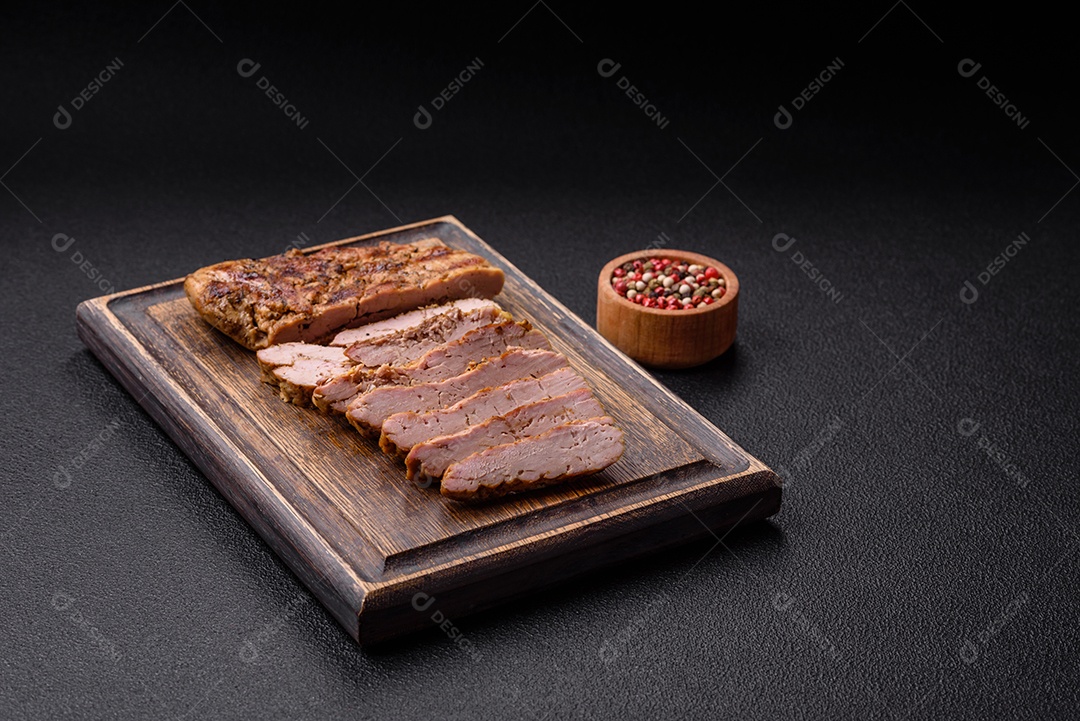 Delicioso peru suculento ou bife de frango com sal, especiarias e ervas sobre um fundo escuro de concreto