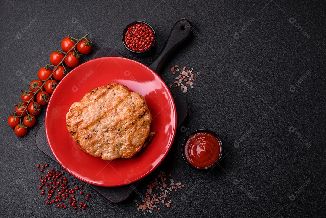 Delicioso peru suculento ou bife de frango com sal, especiarias e ervas sobre um fundo escuro de concreto