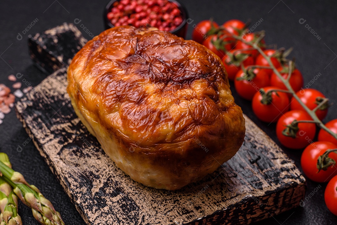 Rolo delicioso ou linguiça de frango picada caseira com sal, especiarias e ervas sobre um fundo escuro de concreto