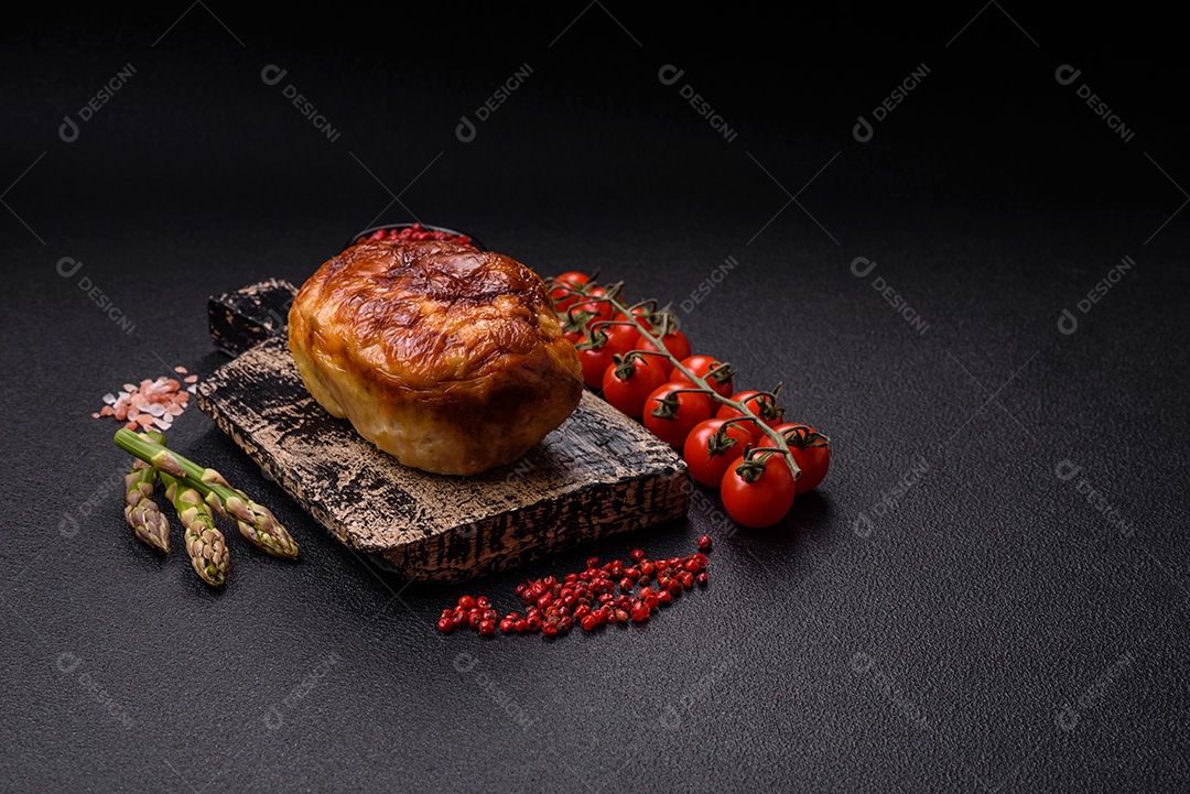 Rolo delicioso ou linguiça de frango picada caseira com sal, especiarias e ervas sobre um fundo escuro de concreto