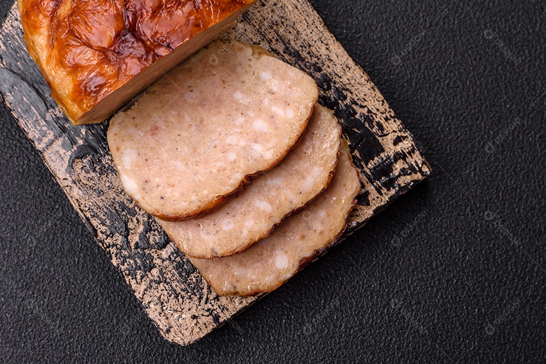 Rolo delicioso ou linguiça de frango picada caseira com sal, especiarias e ervas sobre um fundo escuro de concreto