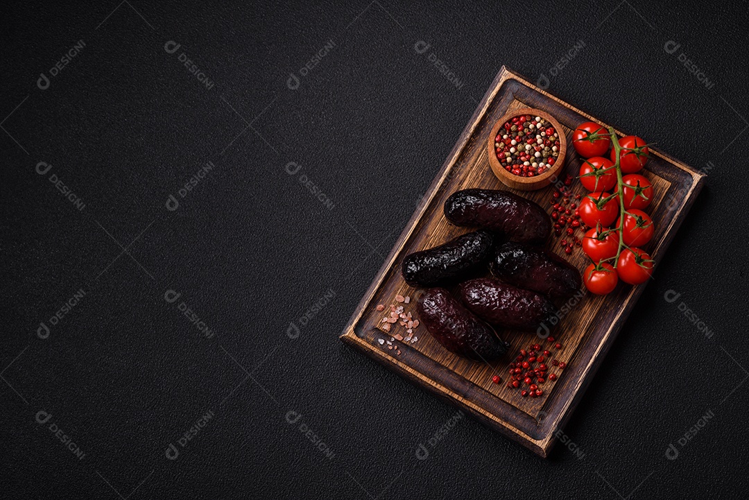 Delicioso chouriço preto ou morcela com especiarias e ervas grelhadas sobre fundo de concreto preto