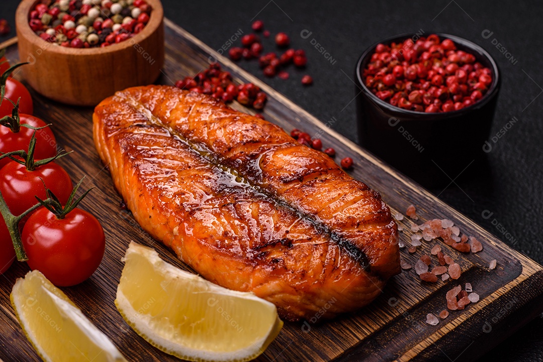 Bife de salmão delicioso cozido fresco com especiarias e ervas assadas em uma grelha. Comida saudável de frutos do mar