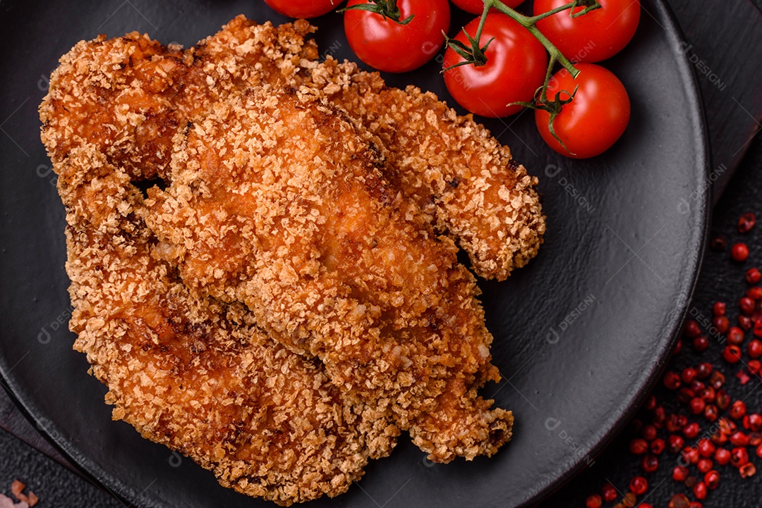 Deliciosos nuggets de frango crocantes frescos em um fundo escuro de concreto. Alimentos não saudáveis, fast food