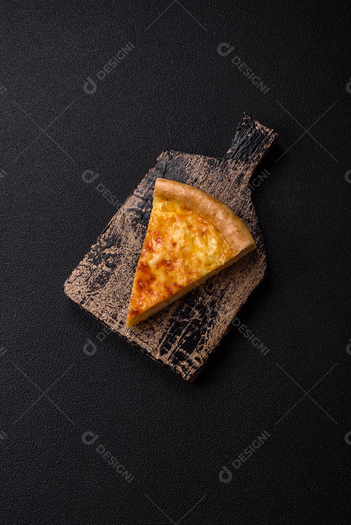 Deliciosa quiche com brócolis, frango ou salmão e queijo com sal e especiarias sobre fundo escuro de concreto