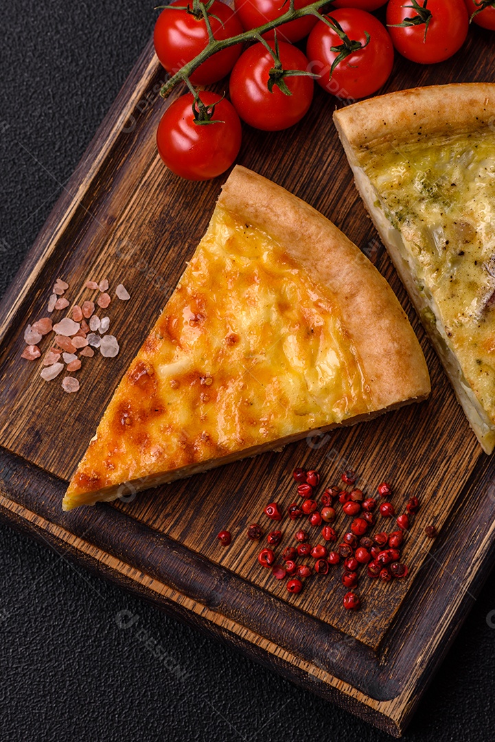 Deliciosa quiche com brócolis, frango ou salmão e queijo com sal e especiarias sobre fundo escuro de concreto