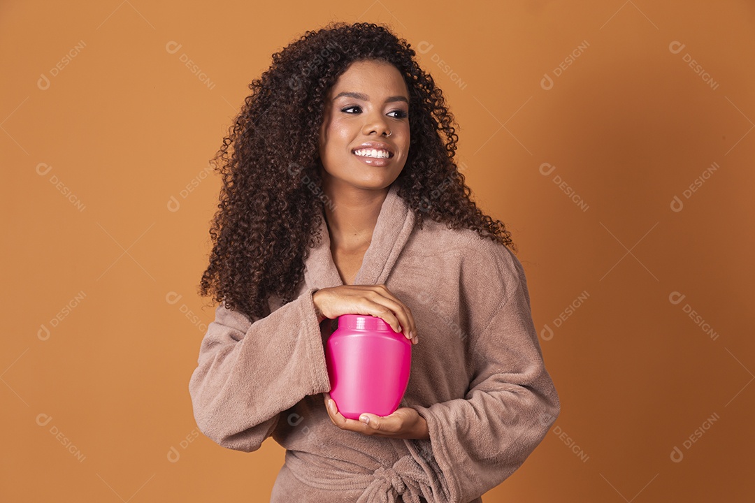 Jovem feliz demais com pote de creme nas mãos