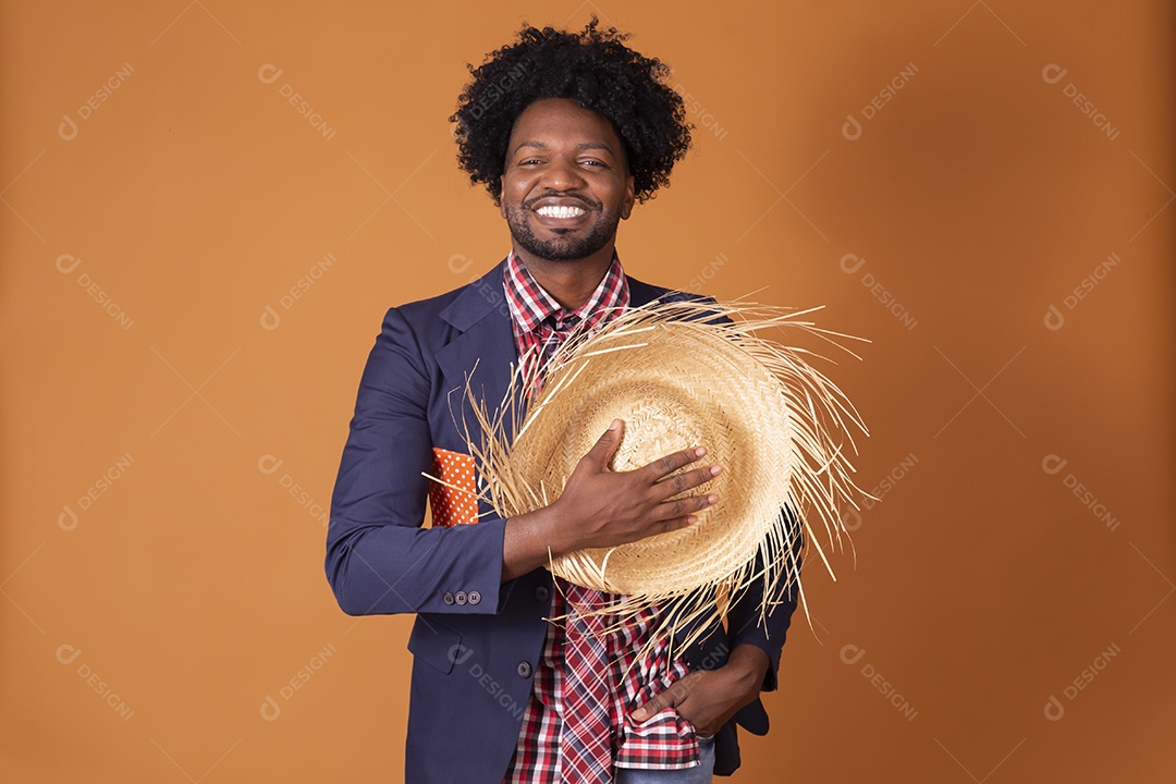 homem trajado e com chapéu de palha na mão