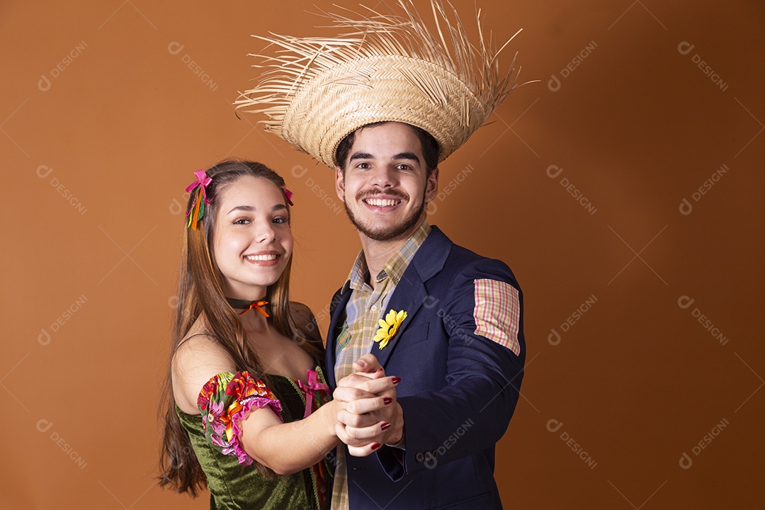 Casal de mãos dada trajados para festa junina