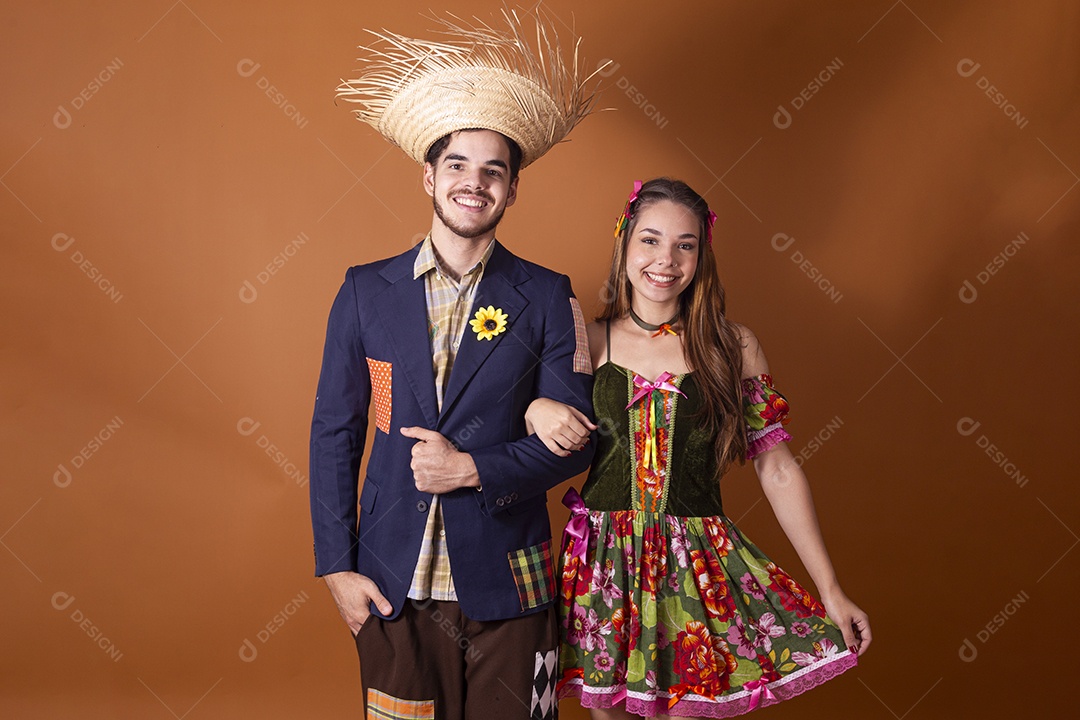 Casal de quadrilheiros de braços dados e sorrindo