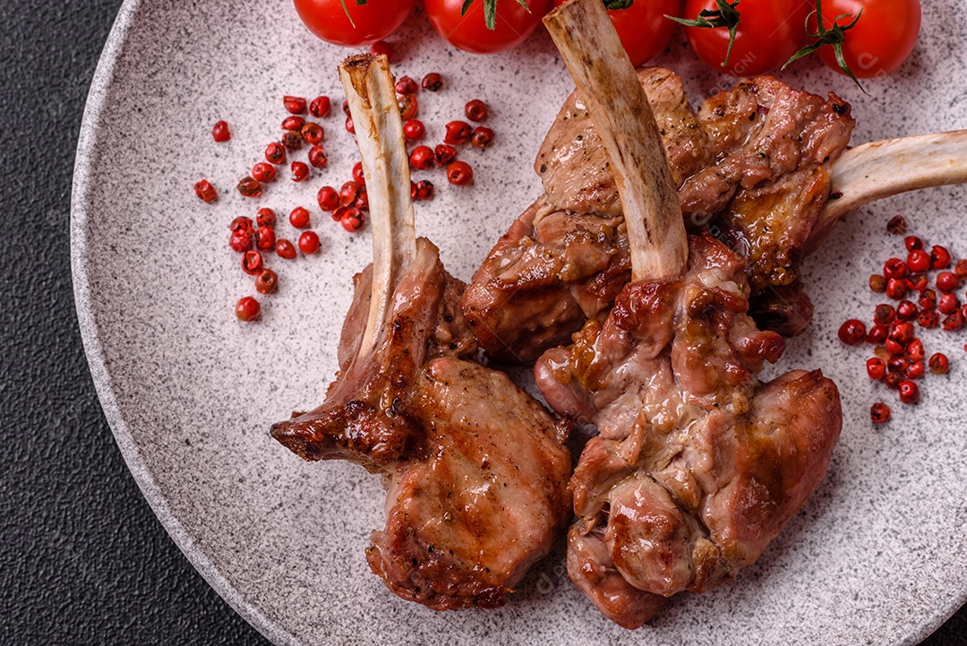 Deliciosa carne suculenta com osso ou costela de cordeiro ou vitela grelhada com sal, especiarias e ervas