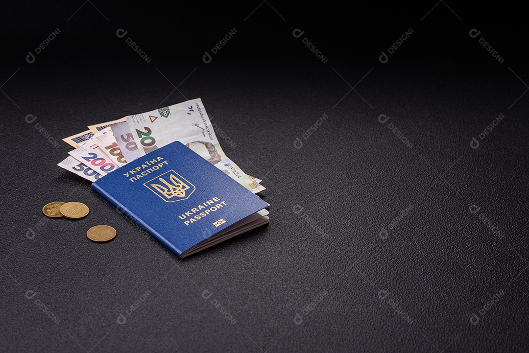Passaporte ucraniano biométrico, passagens aéreas e dinheiro em um fundo escuro de concreto. Antecedentes conceituais sobre o tema turismo e viagens