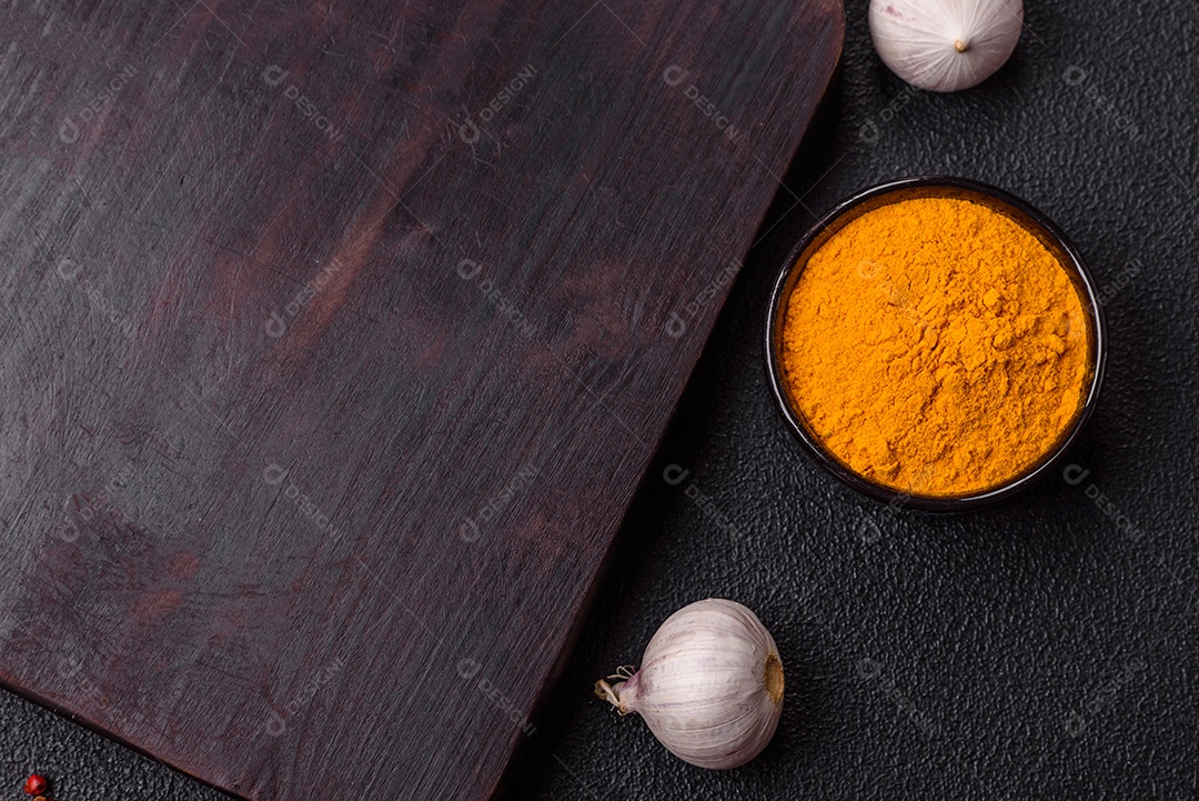 Tábua de madeira vazia com especiarias, sal e ervas em fundo escuro de concreto