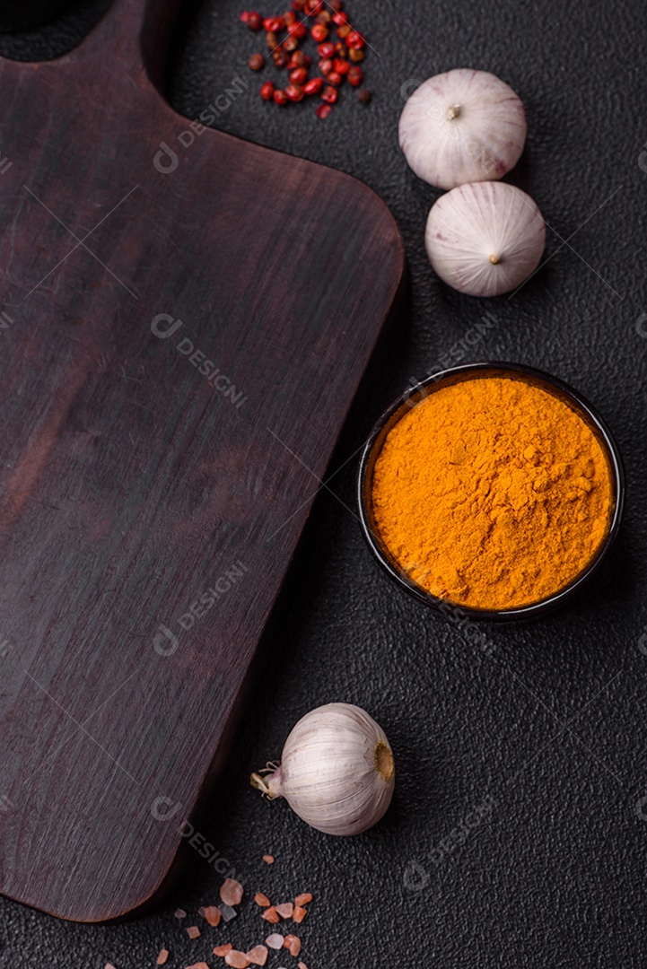 Tábua de madeira vazia com especiarias, sal e ervas em fundo escuro de concreto