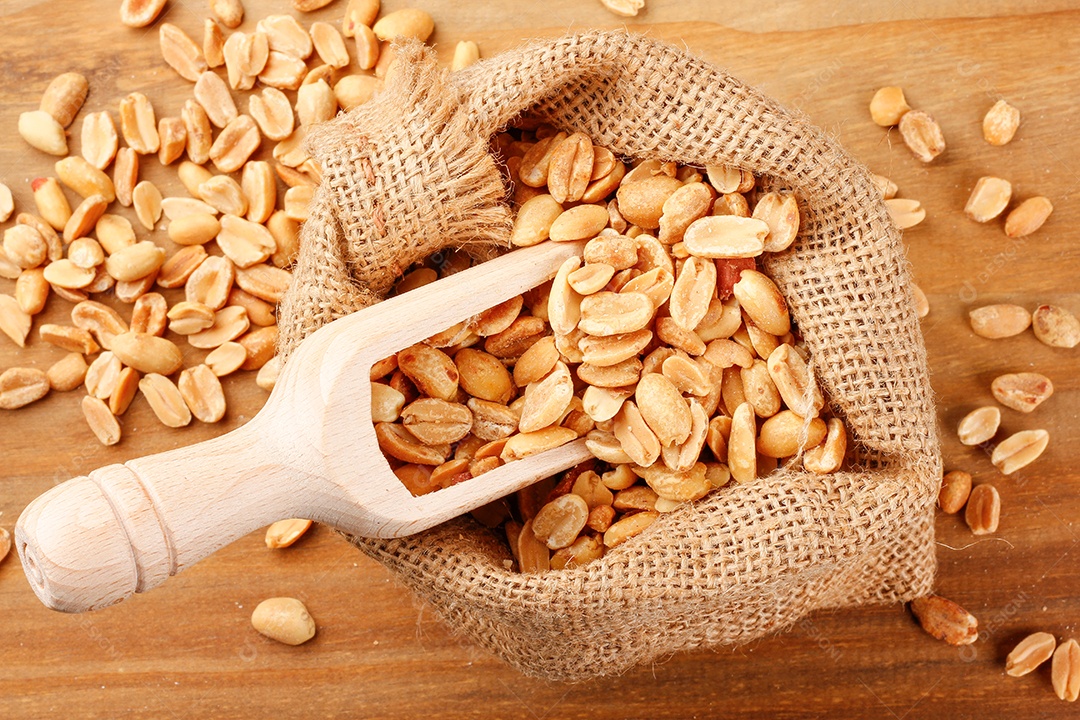 Saco de amendoim e colher pegando o amendoim