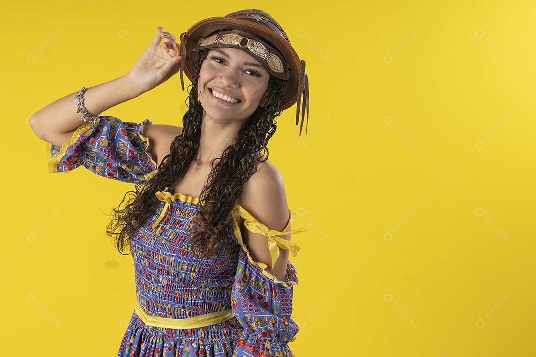 Jovem vestindo fantasia de festa junina com chapéu de couro sorrindo