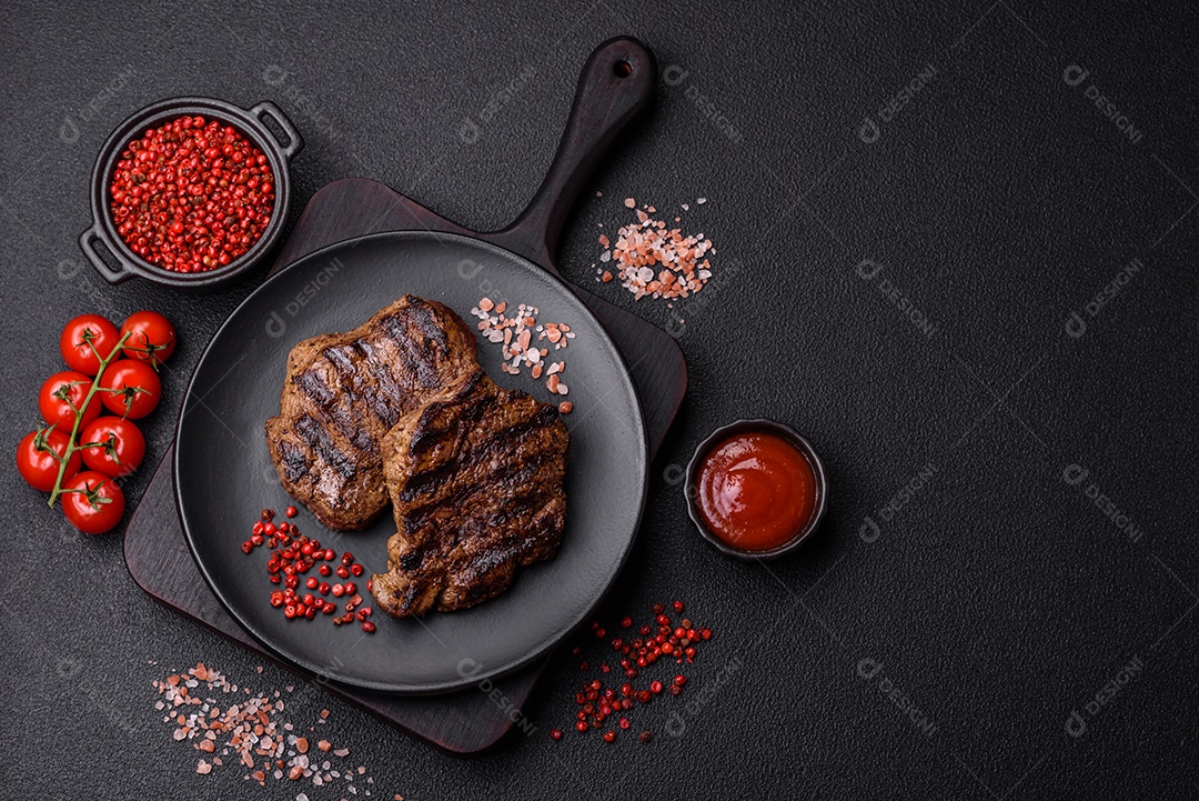 Bife fresco, suculento e delicioso em um fundo escuro. Prato de carne com especiarias e ervas