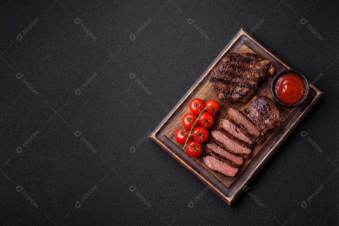 Bife fresco, suculento e delicioso em um fundo escuro. Prato de carne com especiarias e ervas