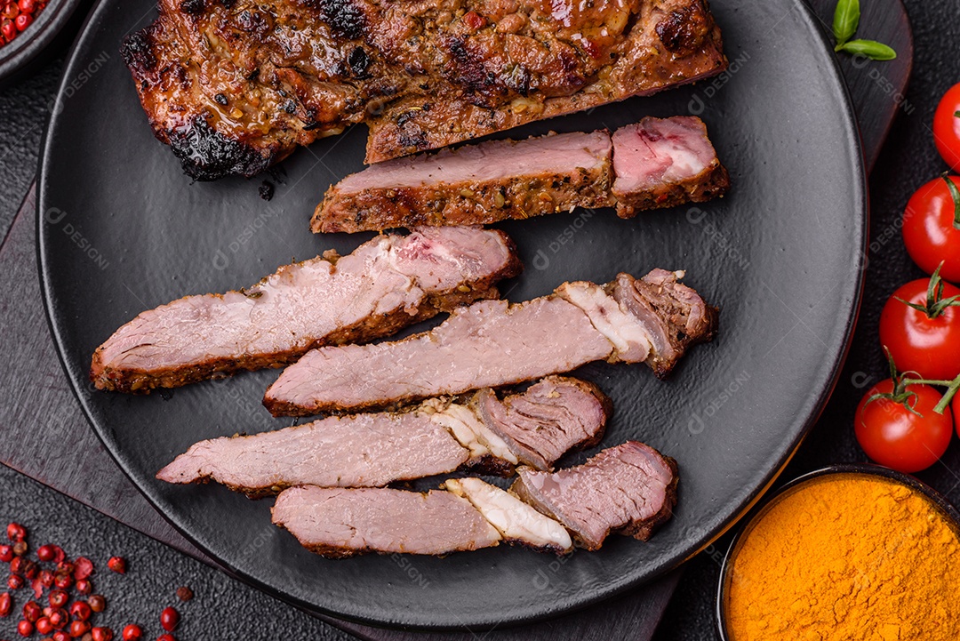 Bife suculento de tomahawk com osso assado na grelha com sal e especiarias em um fundo escuro de concreto