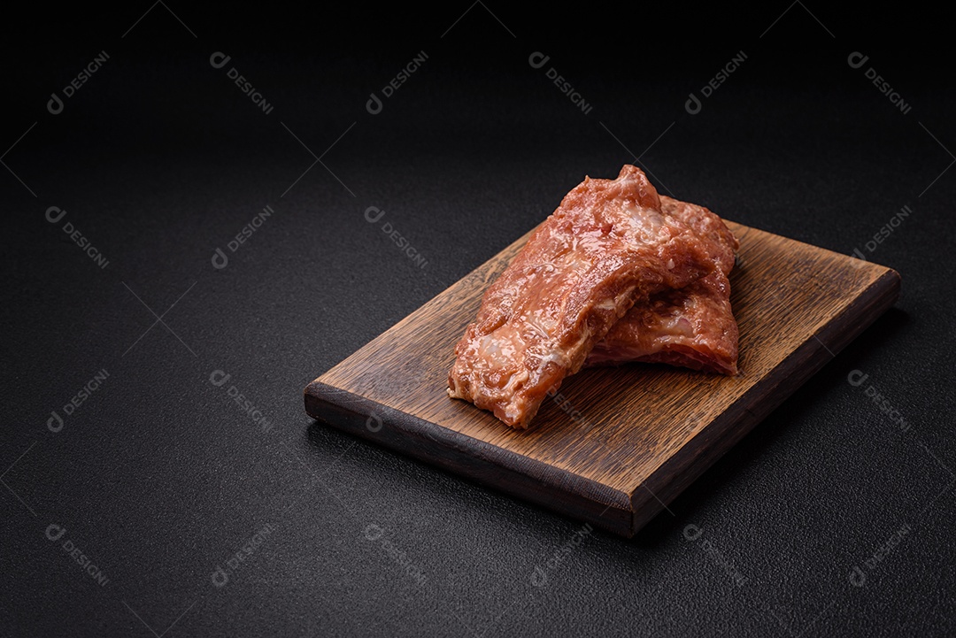 Costelinha de porco ou boi crua ao molho de mel com sal, especiarias e ervas preparadas para grelhar