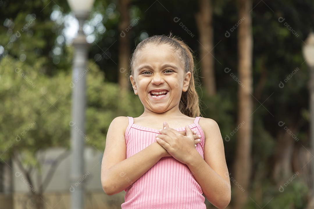 Menina loira linda com mãozinha no peito