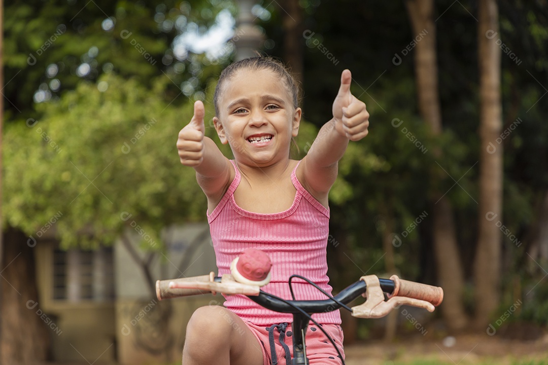 Linda menina na sua bicicleta fazendo gestos de beleza