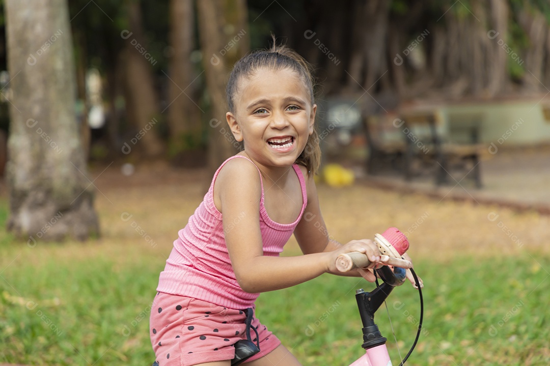 Linda garota feliz andando de bicicleta
