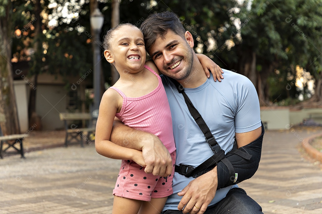 Linda menina abraçando seu pai que está machucado